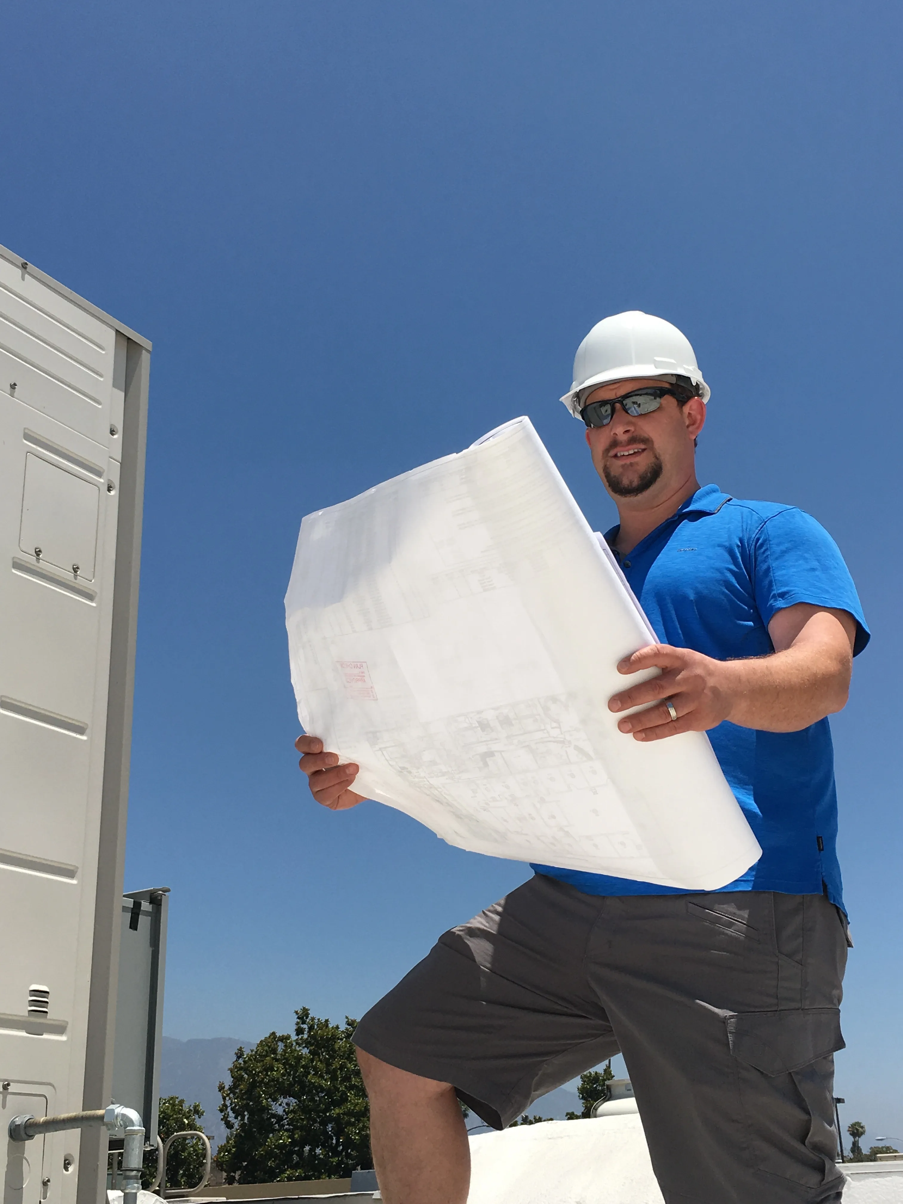 Michael Ruskow reviewing project plans on a construction site